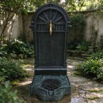 Cast iron antique wall fountain garden ornament placed in garden courtyard